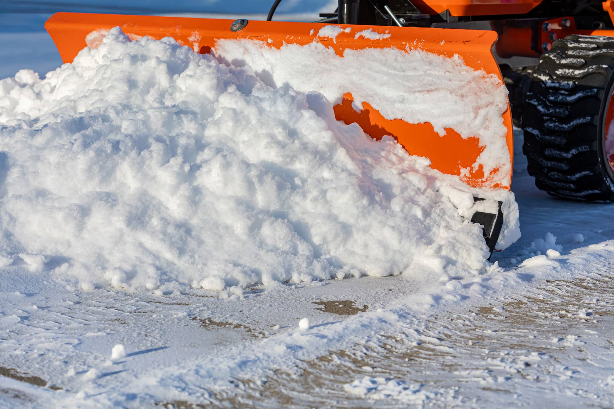 Snow plow in action. Evergreen, CO sees its fair share of snow every winter. How do you take care of slick driveways or inaccessible parts of your property due to snow? Call Happy Hound if you don't have an answer.