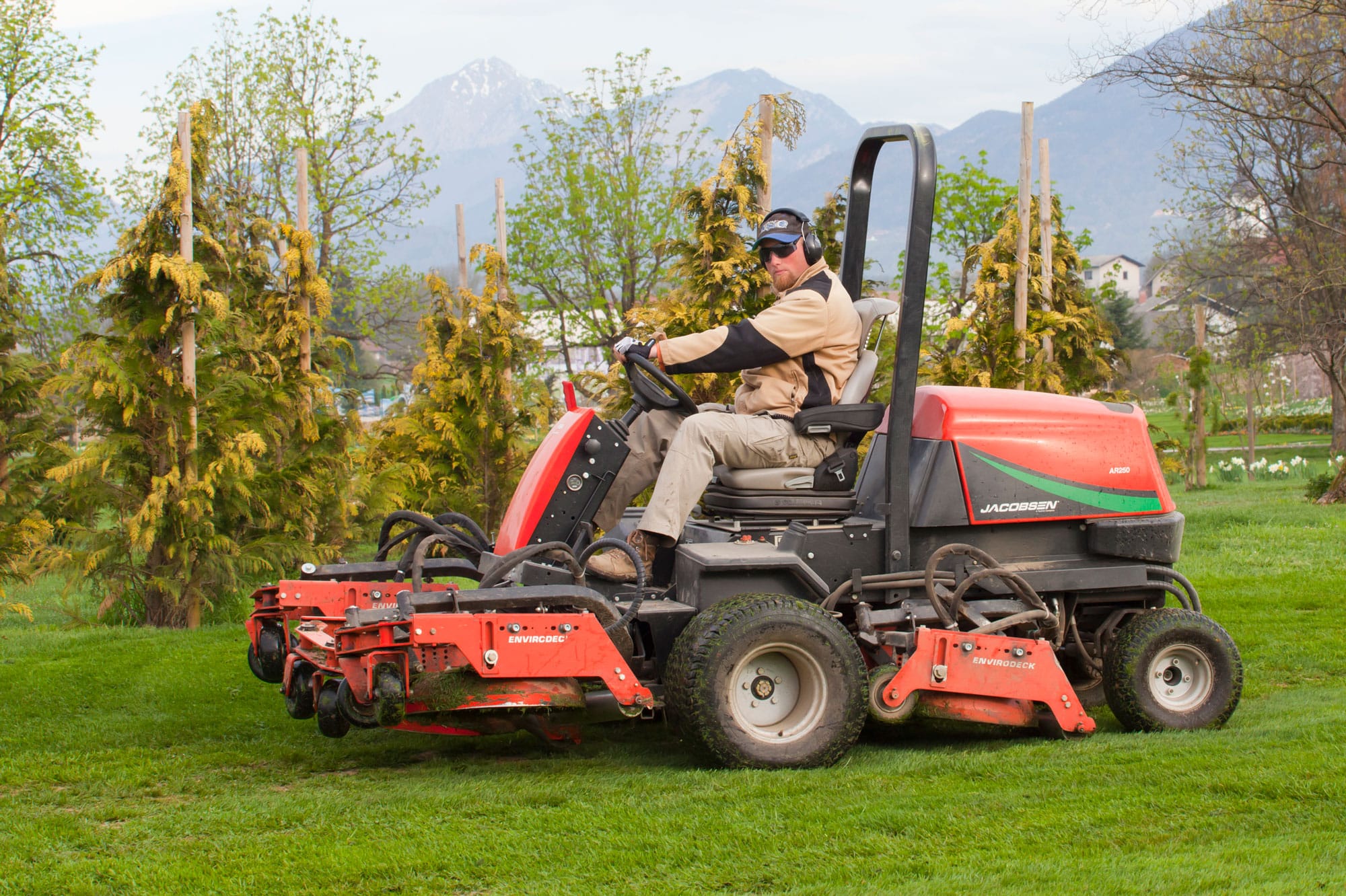 Lawn care professional on a riding lawnmower that landscaping companies often use to make short work of a large yard.